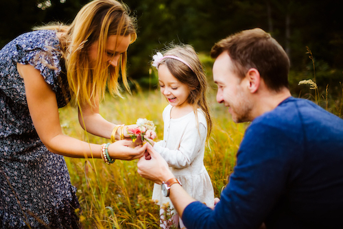 Parents and daughter picking flowers